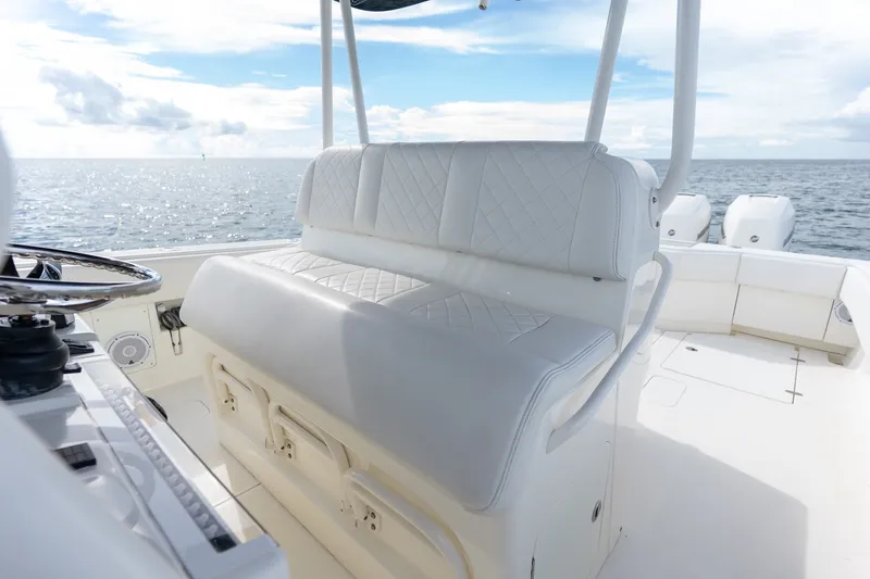 Slide: The Image of 2017 SeaVee 390Z boat interior with white seating and ocean view. - 32