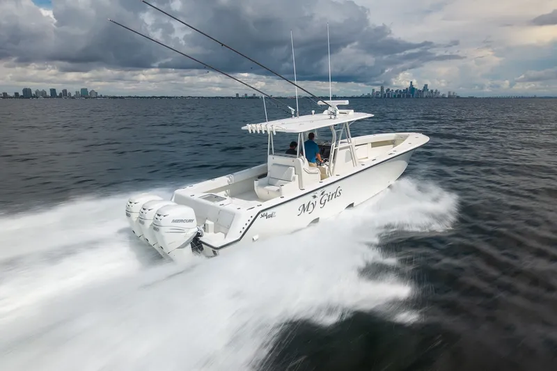 Slide: The Image of 2017 SeaVee 390Z boat speeding on water with city skyline in background. - 5