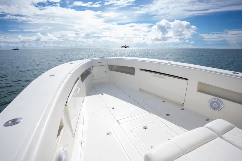 Slide: The Image of 2017 SeaVee 390Z boat deck with ocean view under a partly cloudy sky. - 23