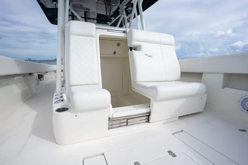 Slide: The Image of 2017 SeaVee 390Z boat interior with white seating and storage compartment. - 18