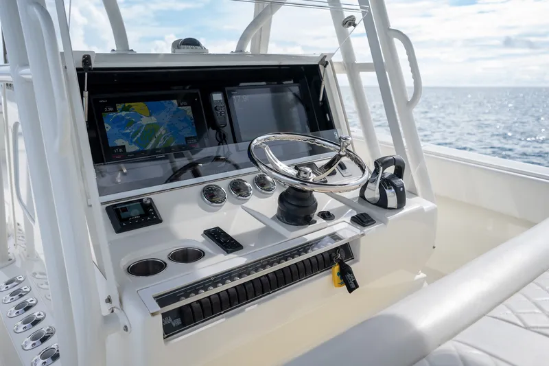 Slide: The Image of 2017 SeaVee 390Z boat dashboard with navigation screens and steering wheel. - 29