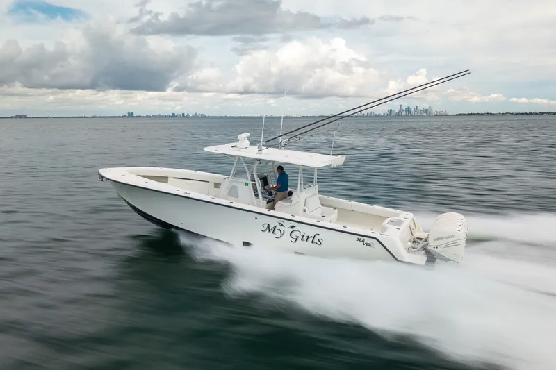 Slide: The Image of 2017 SeaVee 390Z boat speeding on open water with city skyline in background. - 13