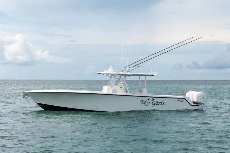 Slide: The Image of 2017 SeaVee 390Z boat named "My Girls" on calm ocean waters. - 2