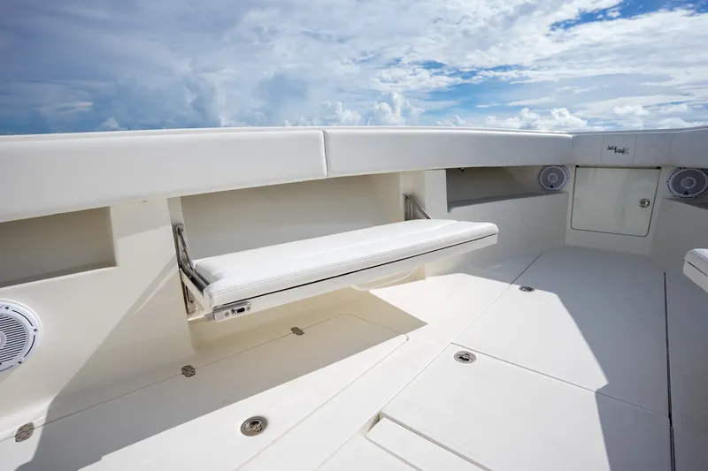 Slide: The Image of 2017 SeaVee 390Z boat interior with white seating and speakers under a blue sky. - 26