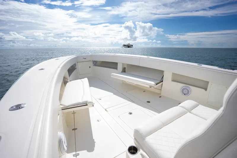 Slide: The Image of 2017 SeaVee 390Z boat interior with white seating, ocean view, and clear sky. - 24