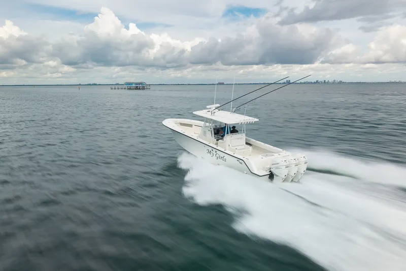 Slide: The Image of 2017 SeaVee 390Z boat speeding on open water under cloudy skies. - 12