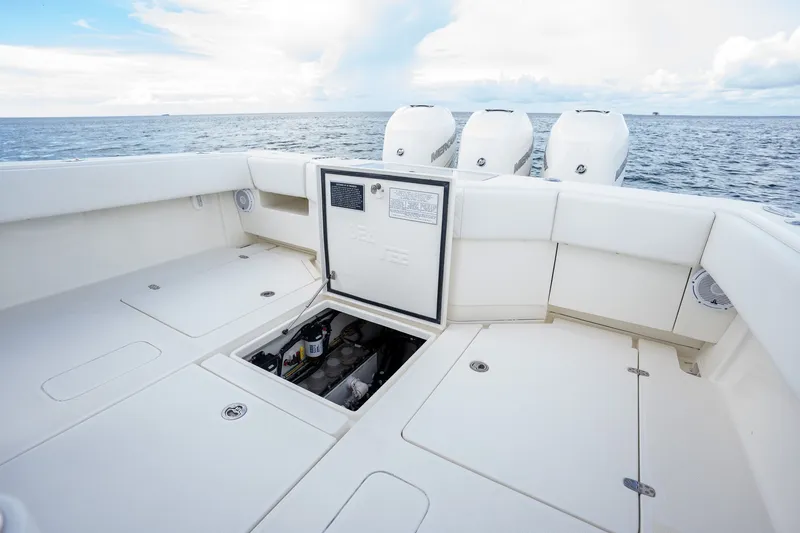 Slide: The Image of 2017 SeaVee 390Z boat deck with open hatch, ocean view, and triple outboard engines. - 37