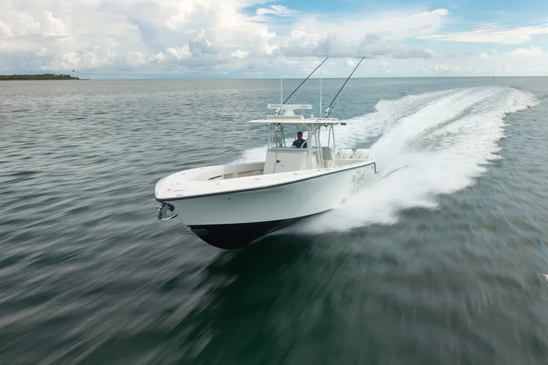 Slide: The Image of 2017 SeaVee 390Z boat speeding on open water under a cloudy sky. - 1