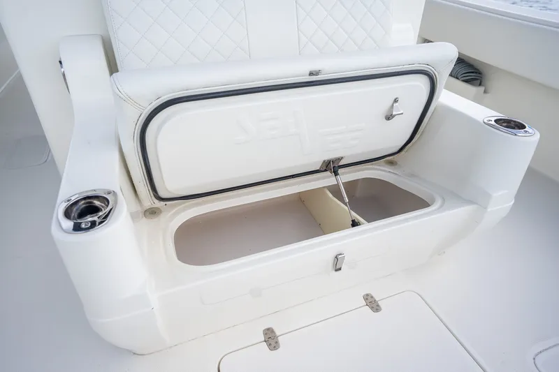 Slide: The Image of 2017 SeaVee 390Z boat seat with open storage compartment and cup holders. - 41