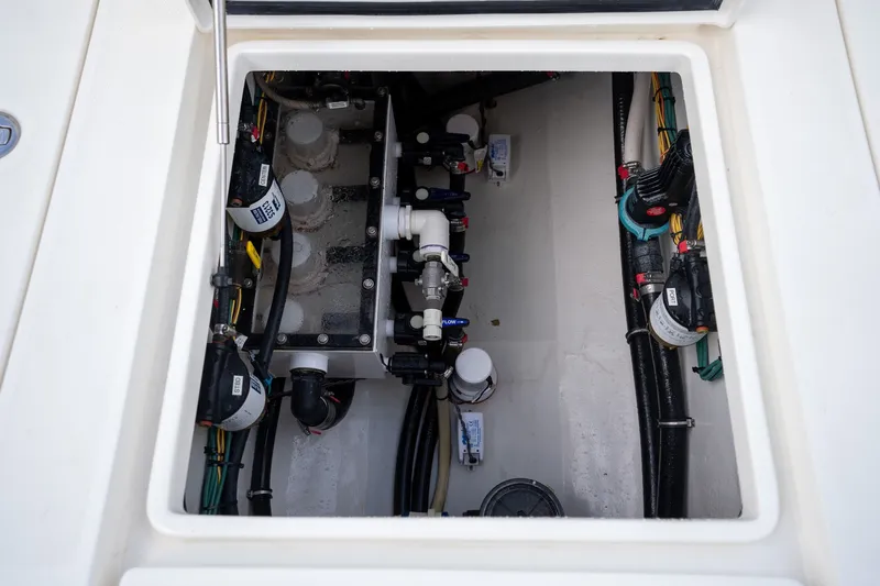 Slide: The Image of Engine compartment of a 2017 SeaVee 390Z boat, showcasing mechanical components and wiring. - 36