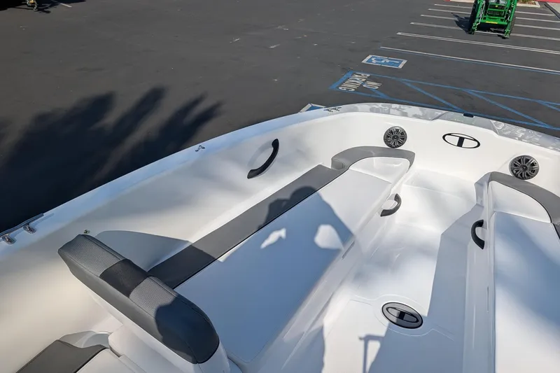 Slide: The Image of 2027 Tahoe T18 boat interior with seating and speakers in a parking lot. - 11