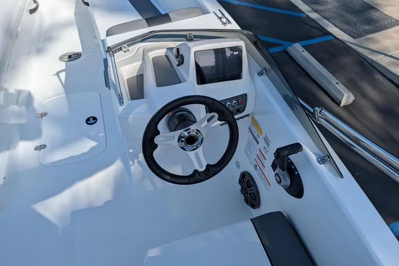 Slide: The Image of 2027 Tahoe T18 boat cockpit with steering wheel and control panel. - 13