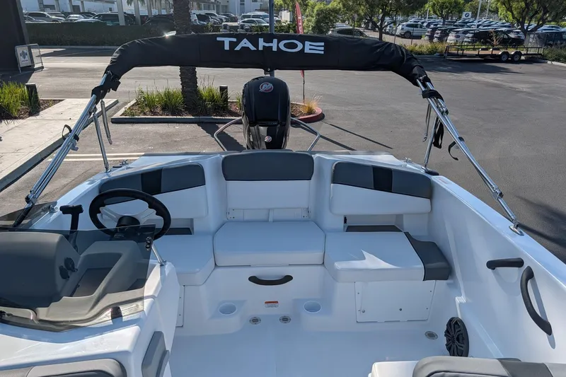 Slide: The Image of 2027 Tahoe T18 boat interior with seating and steering wheel in a parking lot. - 9