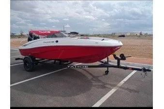 Slide: The Image of 2027 Tahoe T16 boat on trailer in parking lot, cloudy sky background. - 6
