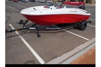 Slide: The Image of A red 2027 Tahoe T16 boat on a trailer in a parking lot. - 5