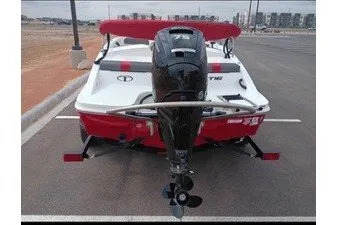 Slide: The Image of 2027 Tahoe T16 boat with outboard motor, parked on a road. - 2
