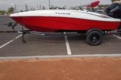 The Image of 2027 Tahoe T16 boat in parking lot, red and white design, side view. - 0
