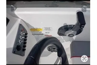 Slide: The Image of The image shows a boat's helm with a steering wheel and control levers. - 8