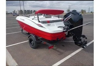 Slide: The Image of 2027 Tahoe T16 boat with red and white design, parked on asphalt. - 3