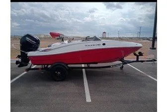 Slide: The Image of A red and white motorboat on a trailer in a parking lot. - 4
