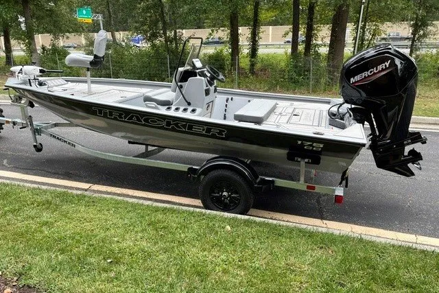 The Image of 2027 Tracker Bass Tracker 175 CC boat with Mercury engine on trailer, parked roadside. - 0