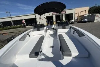 Slide: The Image of 2027 Tahoe T21 boat with sleek seating and canopy, parked outdoors. - 4