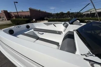 Slide: The Image of 2027 Tahoe T21 boat interior with sleek white and gray seating, outdoor setting. - 7
