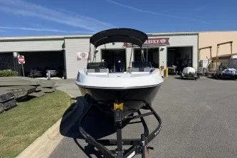 Slide: The Image of 2027 Tahoe T21 boat on trailer outside service center under clear blue sky. - 5