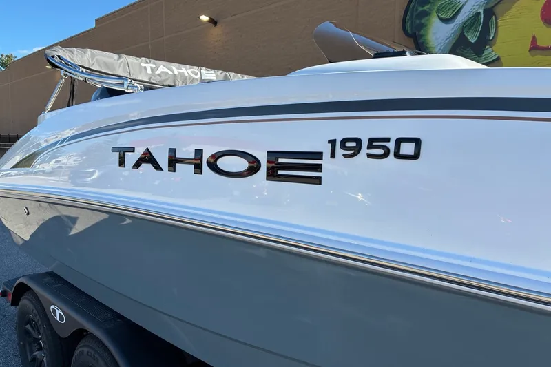 Slide: The Image of 2027 Tahoe 1950 boat, sleek design, parked outdoors, showcasing modern features. - 2