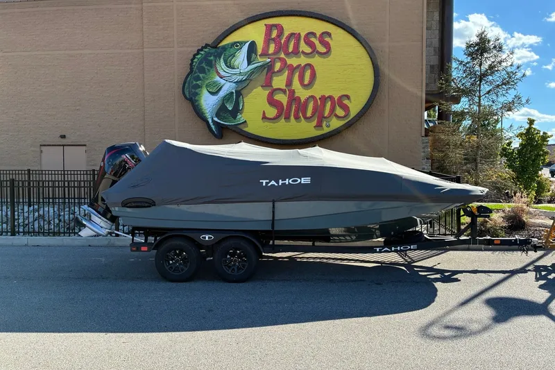Slide: The Image of Covered 2027 Tahoe 1950 boat on trailer outside Bass Pro Shops. - 12