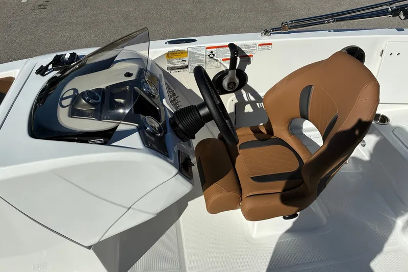 Slide: The Image of Steering console of a 2027 Tahoe 1950 boat with brown seat and modern controls. - 7