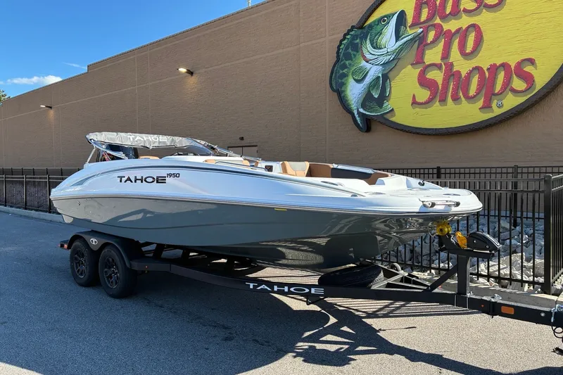 Slide: The Image of 2027 Tahoe 1950 boat on trailer outside Bass Pro Shops. - 4