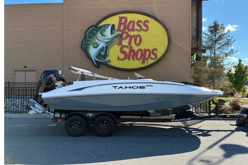 Slide: The Image of 2027 Tahoe 1950 boat on trailer outside Bass Pro Shops store. - 1