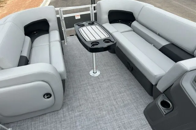 Slide: The Image of 2027 Sun Tracker SportFish 22 DLX interior with gray seating and central table. - 15