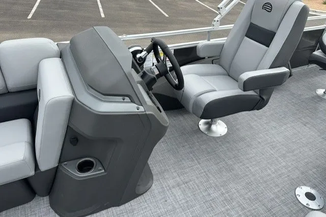 Slide: The Image of 2027 Sun Tracker SportFish 22 DLX boat interior with gray seating and steering console. - 19