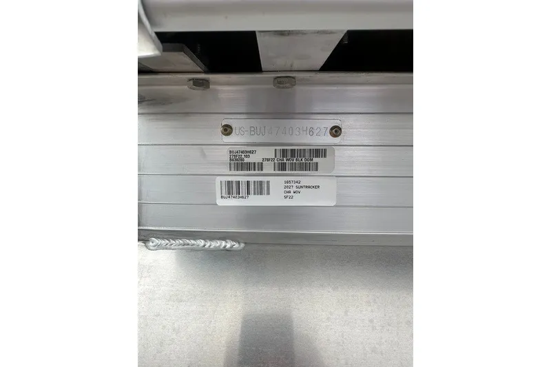 Slide: The Image of 2027 Sun Tracker SportFish 22 DLX identification plate with serial numbers and barcodes. - 100