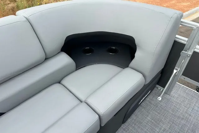 Slide: The Image of 2027 Sun Tracker SportFish 22 DLX boat interior with gray cushioned seating and cup holders. - 14