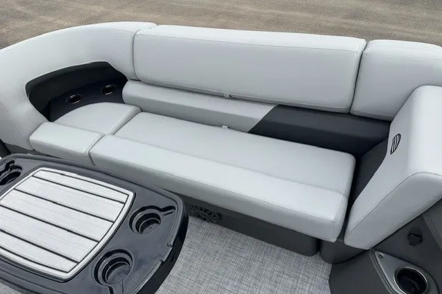 Slide: The Image of 2027 Sun Tracker SportFish 22 DLX boat interior with gray seating and cup holders. - 13