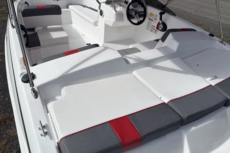 Slide: The Image of 2027 Tahoe T16 boat interior with white and red seating, steering wheel, and controls. - 9