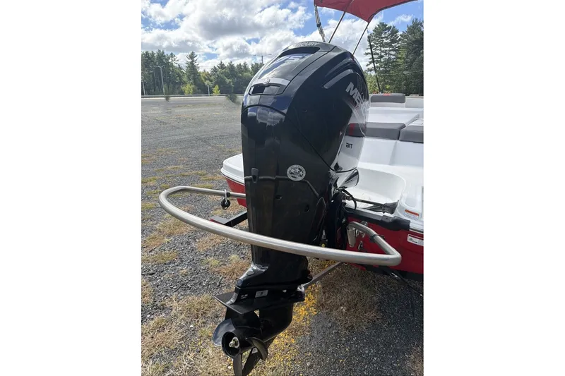 Slide: The Image of 2027 Tahoe T16 boat with Mercury outboard motor, parked outdoors under cloudy sky. - 7