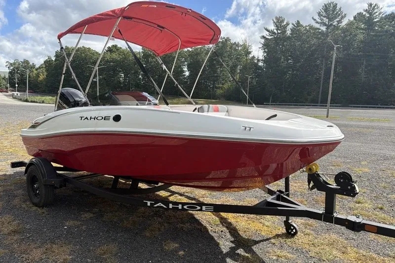 Slide: The Image of 2027 Tahoe T16 boat with red hull and canopy on a trailer. - 1