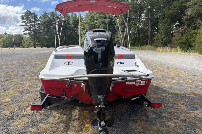 Slide: The Image of Rear view of a 2027 Tahoe T16 boat with outboard motor on a trailer. - 6