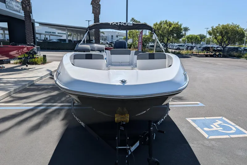 Slide: The Image of 2027 Tahoe T16 boat displayed in a parking lot under clear skies. - 2