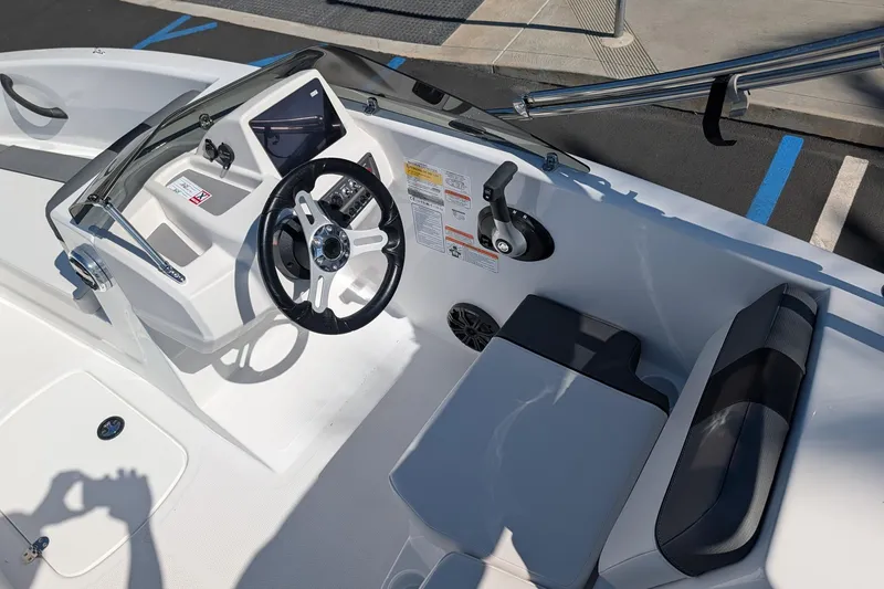 Slide: The Image of 2027 Tahoe T16 boat cockpit with steering wheel, control panel, and seating. - 8