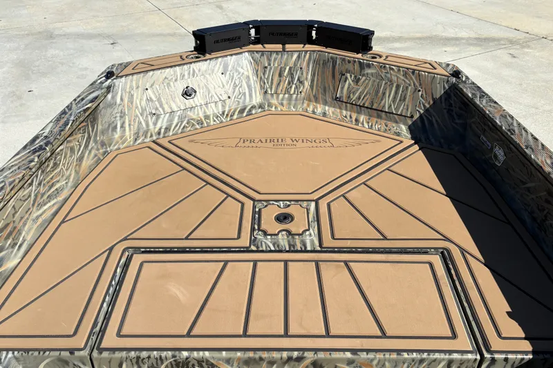 Slide: The Image of 2027 Tracker Grizzly 1650 T Prairie Wings Edition boat interior with camo design and padded flooring. - 23