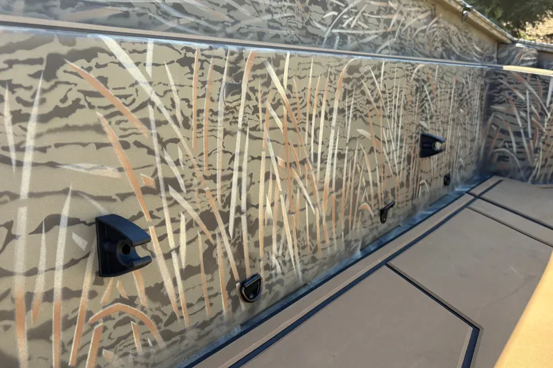 Slide: The Image of 2027 Tracker Grizzly 1650 T Prairie Wings Edition with camouflage design detail. - 19