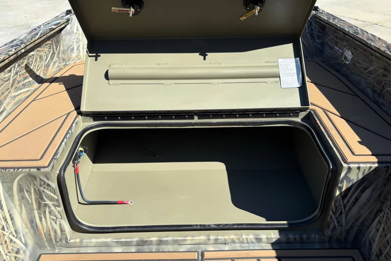 Slide: The Image of Open storage compartment in 2027 Tracker Grizzly 1650 T Prairie Wings Edition boat. - 24