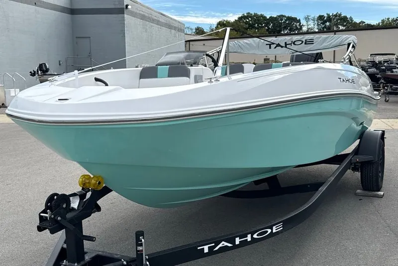 Slide: The Image of 2027 Tahoe T18 boat in mint green on trailer, parked outdoors. - 10