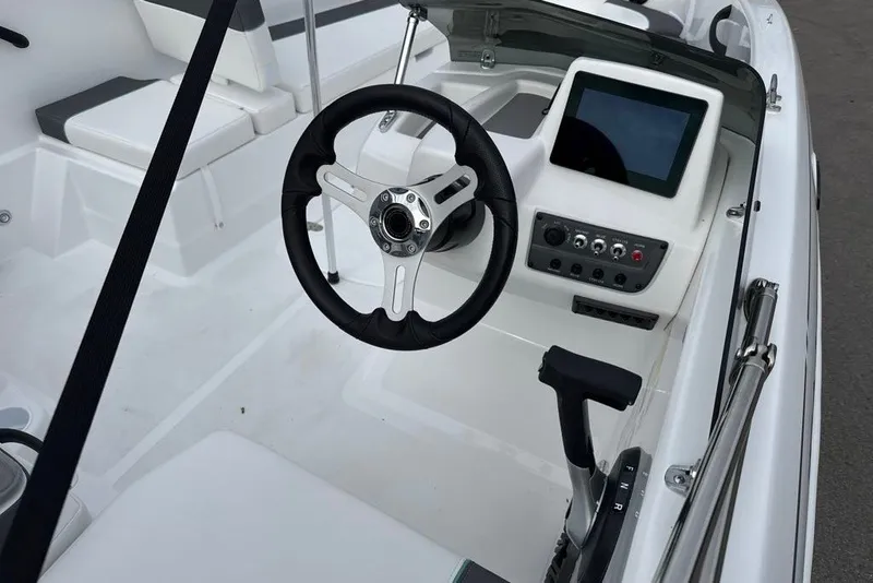 Slide: The Image of Interior of a 2027 Tahoe T18 boat featuring steering wheel and control panel. - 6