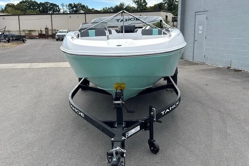 Slide: The Image of 2027 Tahoe T18 boat on trailer, parked outdoors near a building. - 8